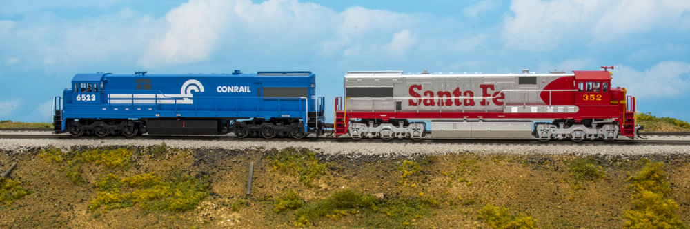 Models of a blue locomotive and red and silver locomotive