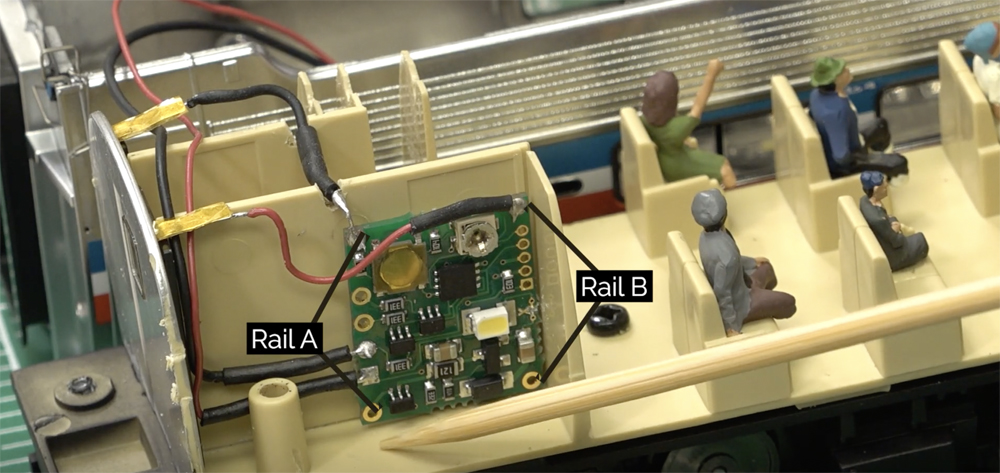 an image of the inside of a model passenger train car with a decoder installed