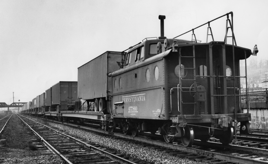 black-and-white photo with caboose at end of train