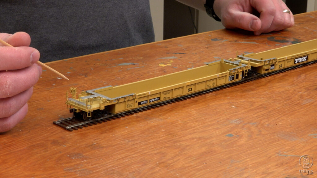 intermodal cars different support wheels: An image of a model freight car on a workbench