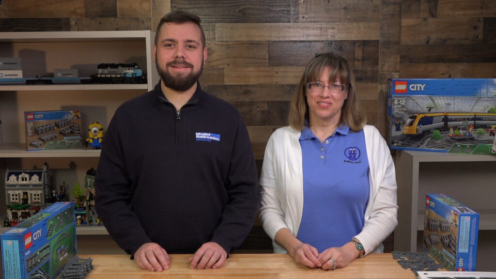 LEGO trackwork basics: An image of two people standing behind a table