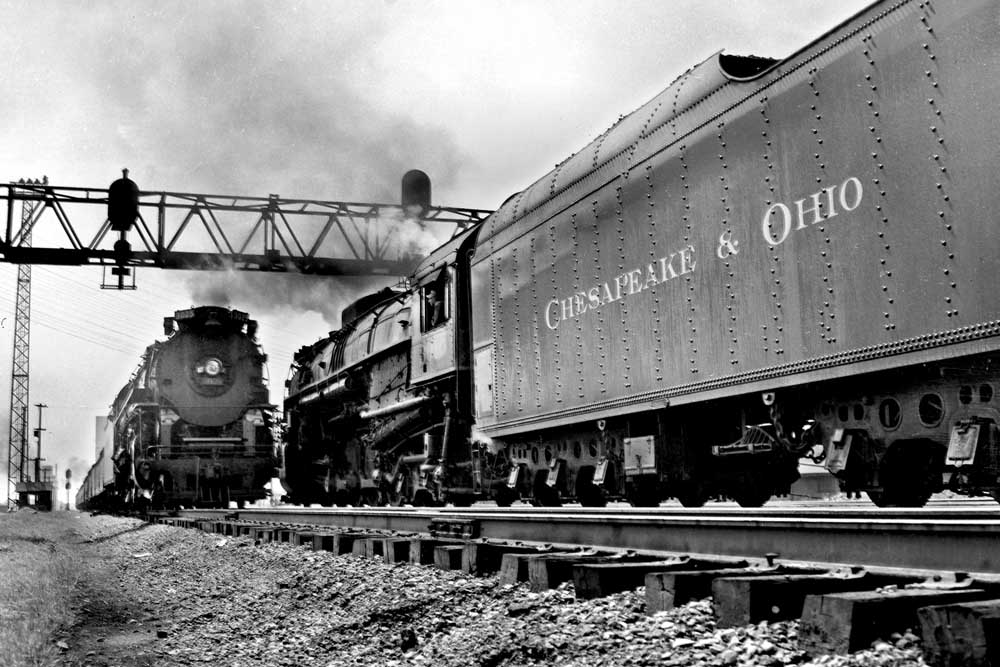 Steam locomotives meet under signal bridge
