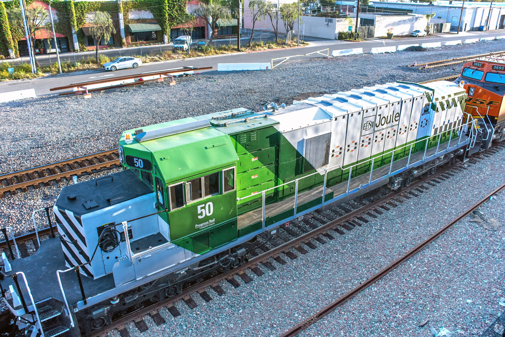 blue, green, and white electric battery locomotive