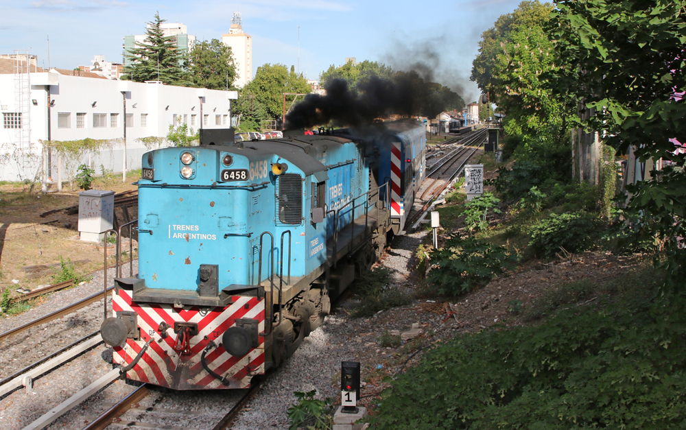 Blue diesel on commuter train belching black smoke