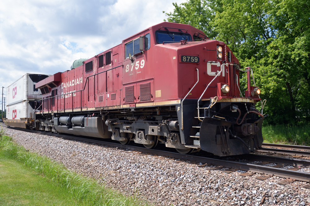 Red locomotive with single intermodal car