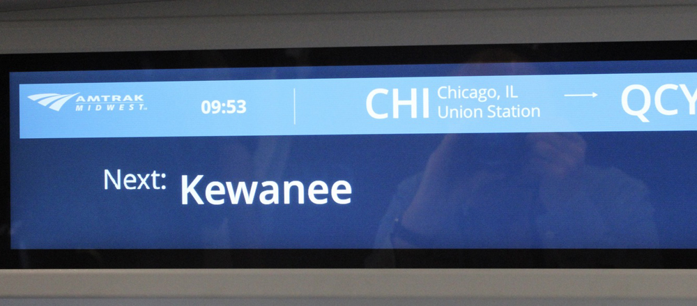 Close-up of display screen showing next city and arrival time