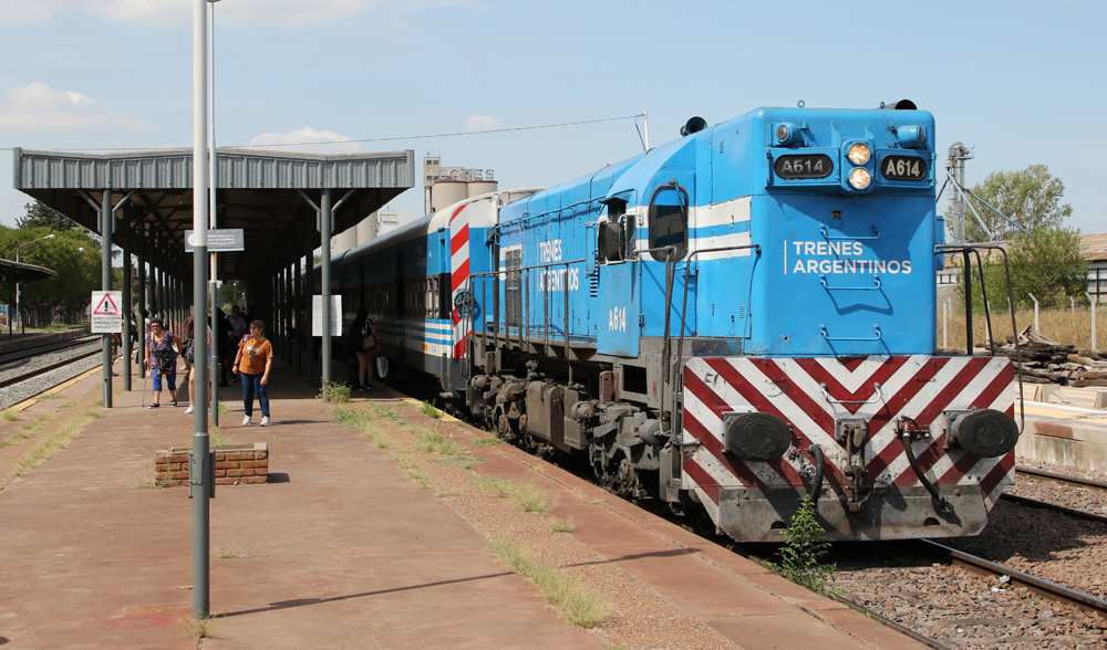 Blue diesel on commuter train at station platform