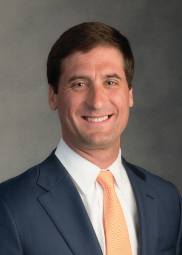 Head shot of man in coat and tie