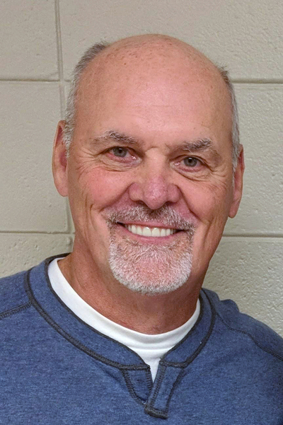 Head shot of man with beard in blue shirt with 