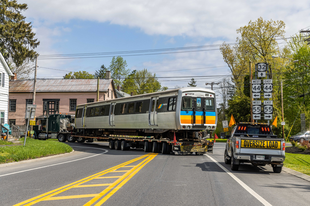 Subway car on truck trailer rounds curve