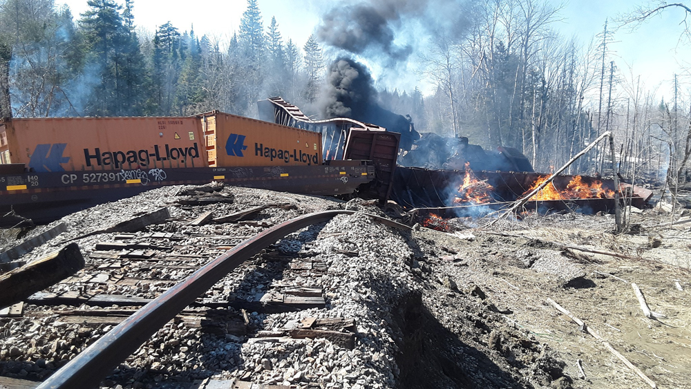 View of damaged track and derailed train