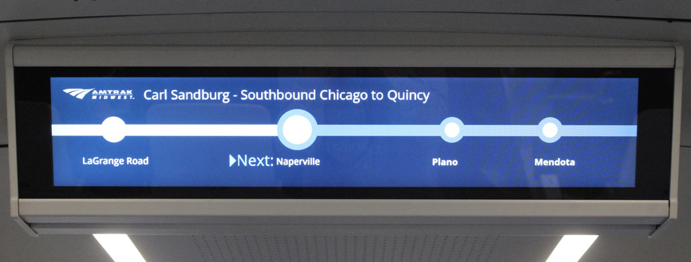 Display screen on ceiling of railcar showing train route