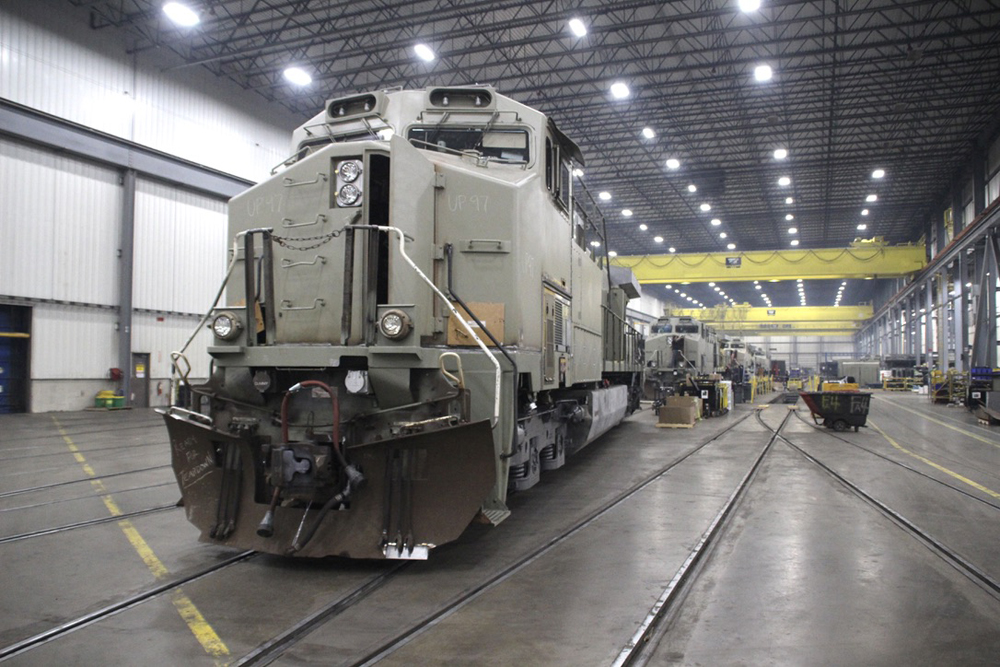 Unpainted locomotive with others visible in background