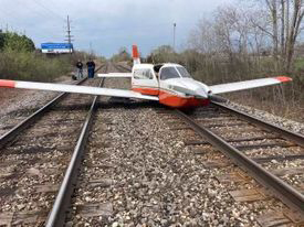 Airplane on railroad tracks