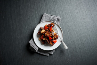 White plate with meal of steak and red peppers. Acela first-class menu upgraded: Analysis