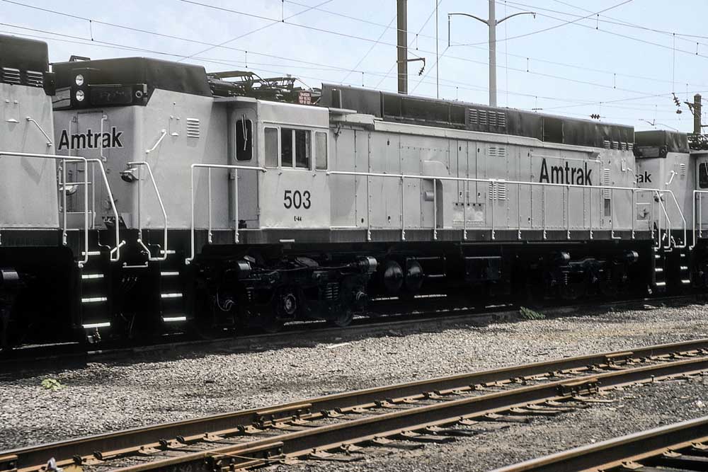 Silver-and-black Amtrak E44 electric locomotives stored in a line