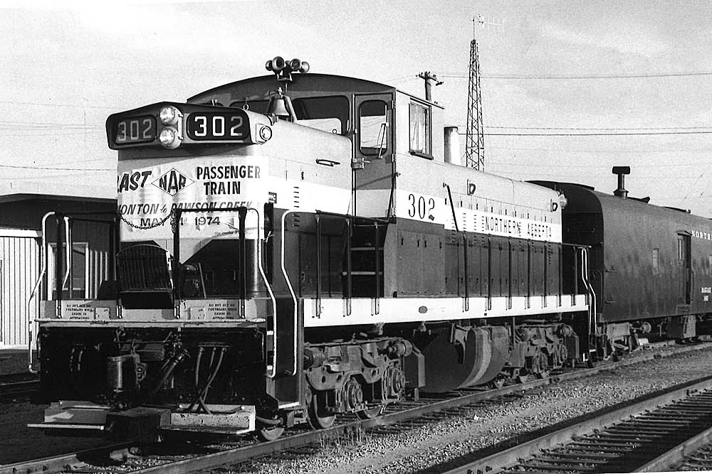 GMD1 diesel locomotive with passenger train and banner on nose 