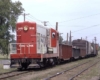 Red-and-white Soo Line diesel locomotive with freight train