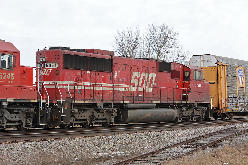 Red-and-white Soo Line diesel locomotive on a freight train