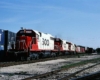 Red-and-white Soo Line diesel locomotives on a freight train