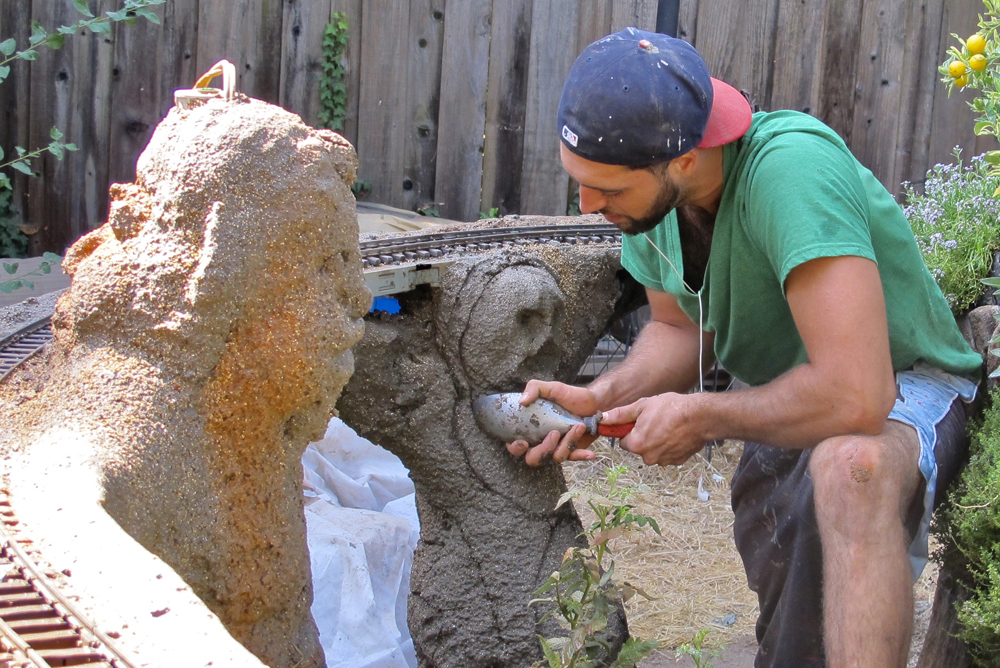 a man sculpting a concrete mixture