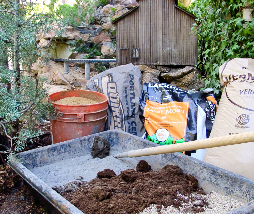 a mixing trough with concrete, peat moss and vermiculite in it