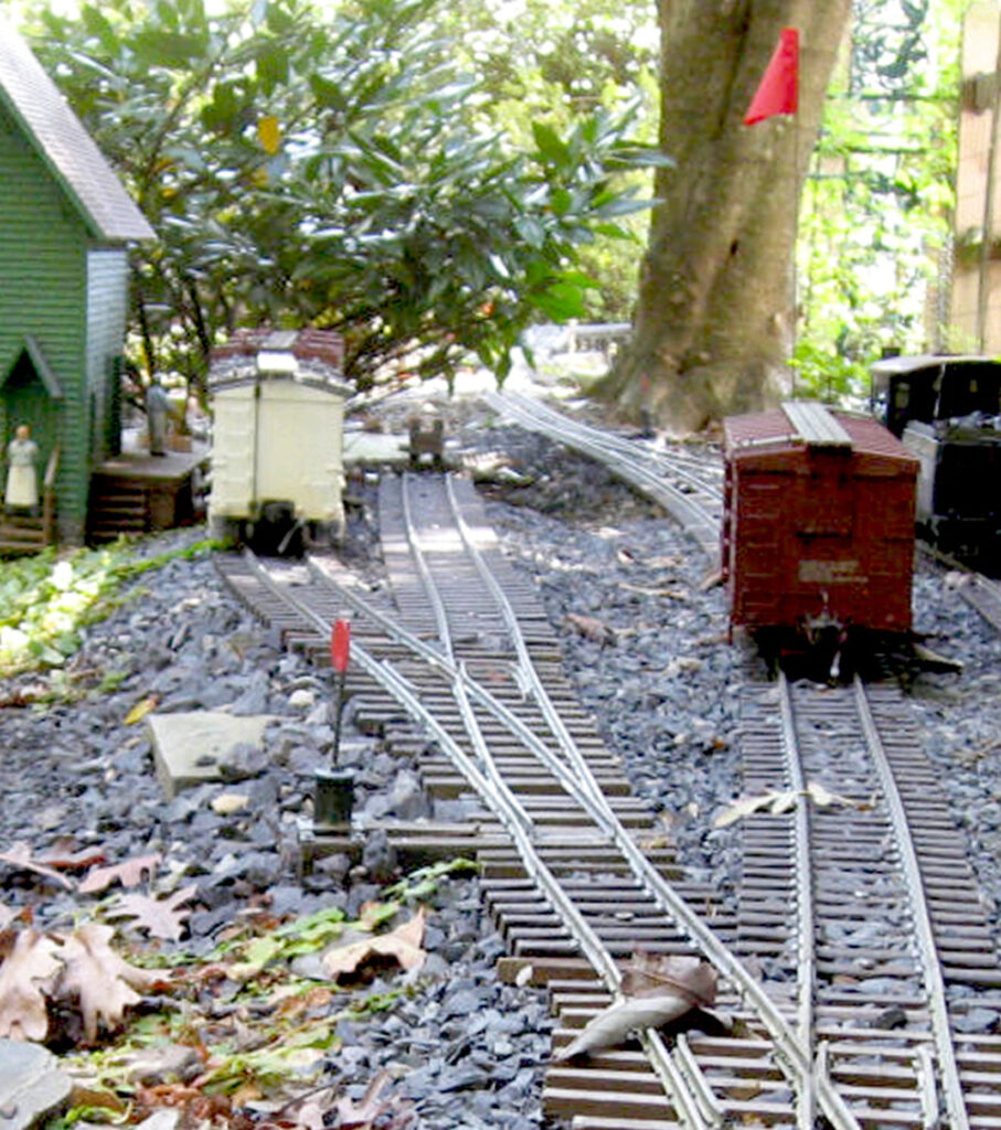 view of garden railway with boxcar at right