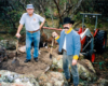 Two men with shovels, next to rocks and dirt