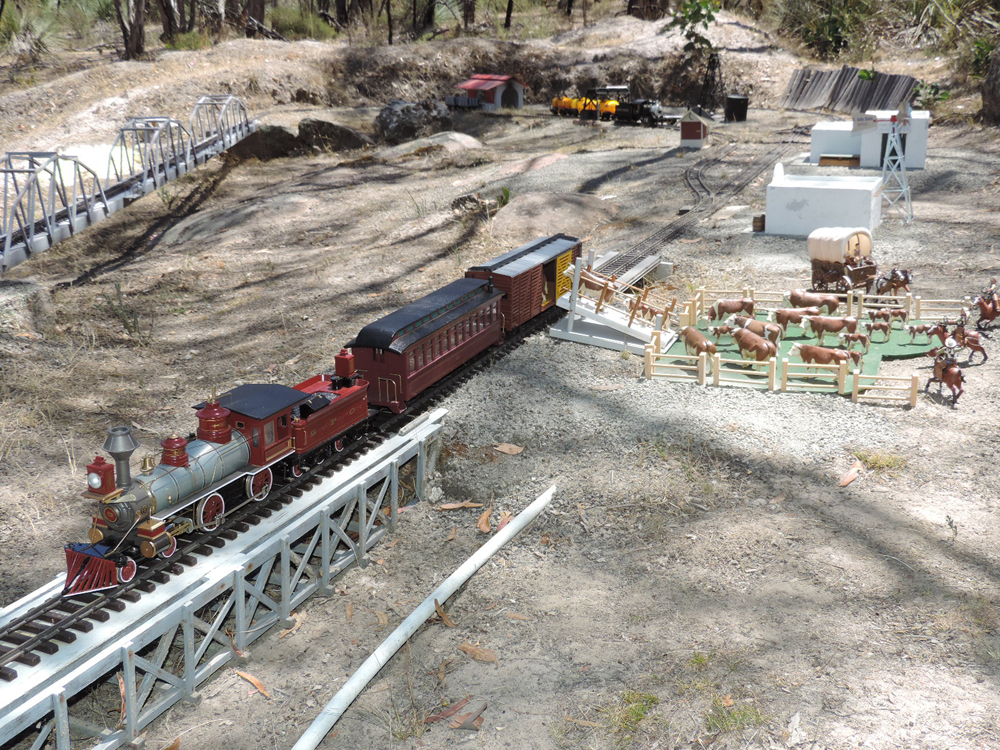 model locomotive on garden railroad loading cattle