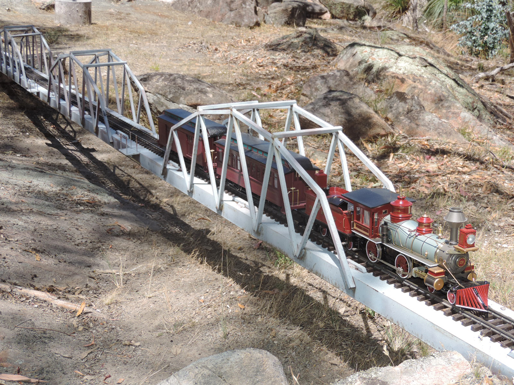 model locomotive crossing steel bridge