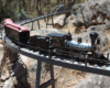 steam locomotive crossing metal bridge