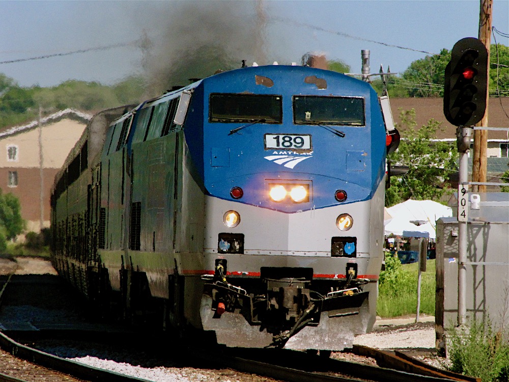A image of the nose of a blue and silver modern passenger locomotive
