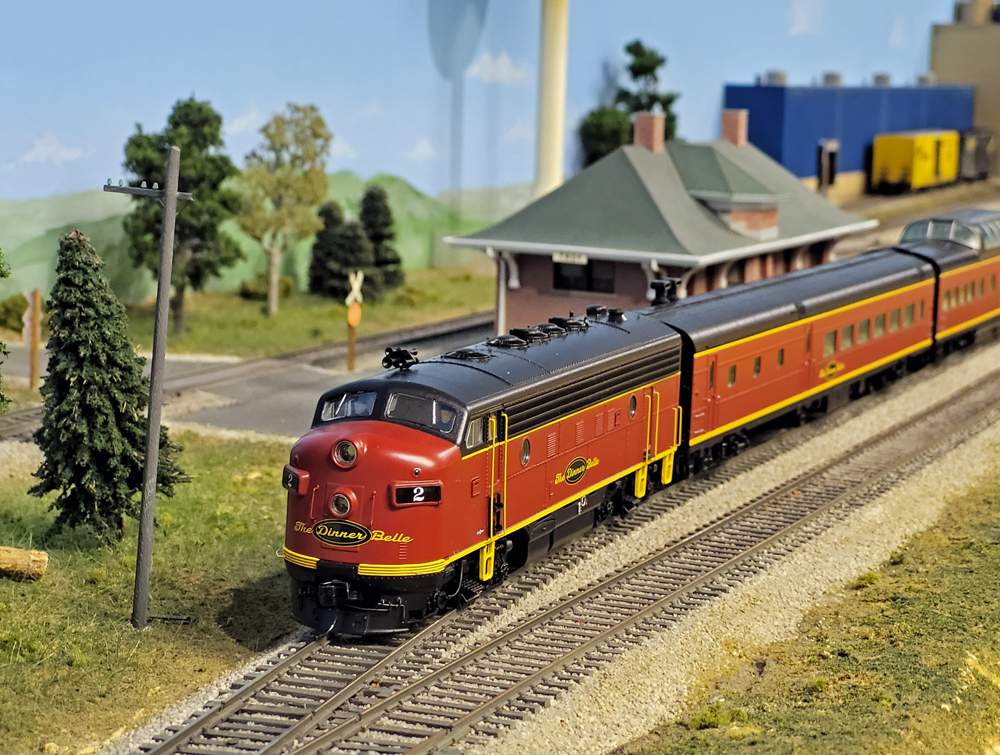 A model passenger train sits at a station