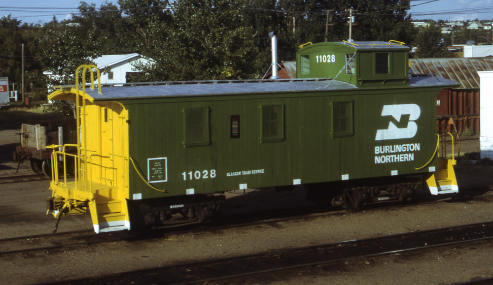 Color photo of wood offset-cupola caboose.