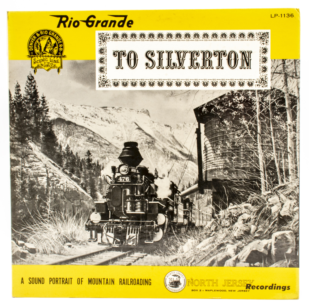 Photo of vinyl record cover with black-and-white image of steam locomotive with yellow, black, and white graphics.
