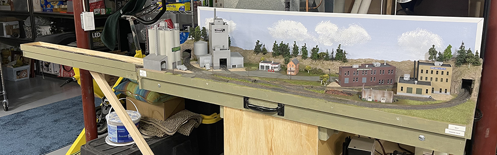 small toy train railroad with fold-up extension adding two additional tracks for train storage
