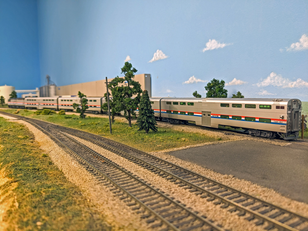 A model passenger train stops at a station.