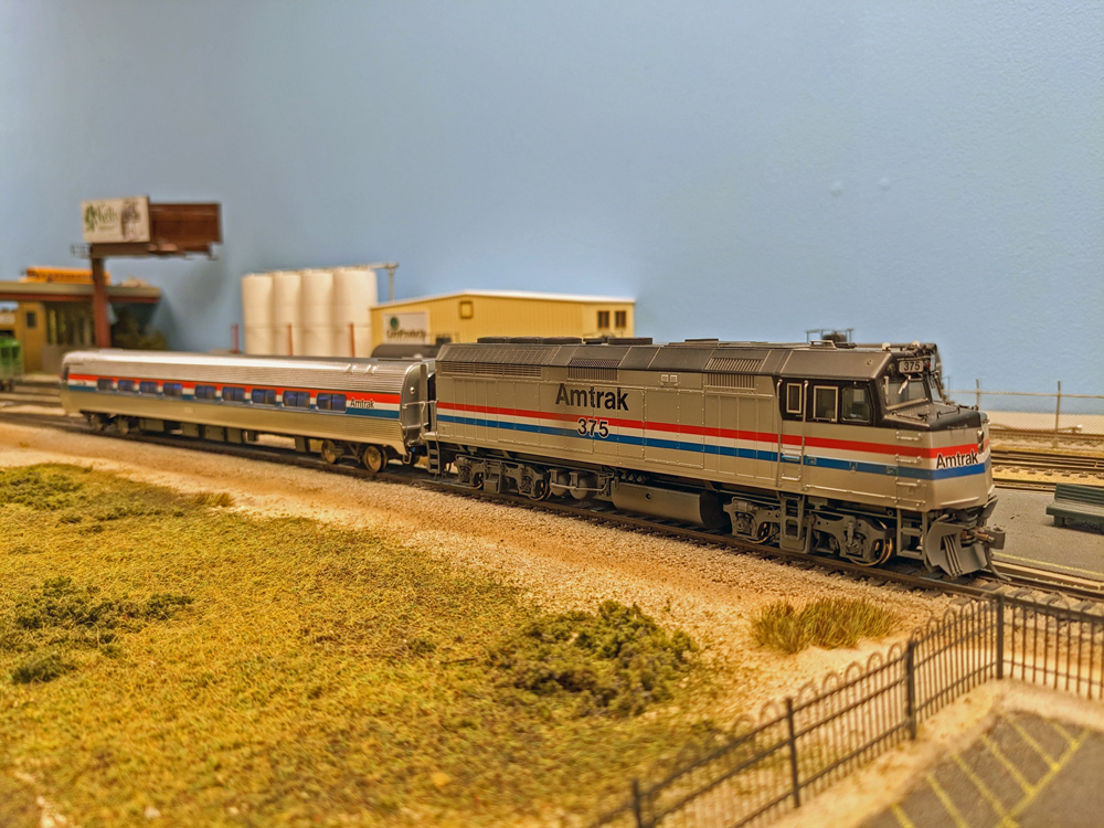 A model passenger train stops at a station.