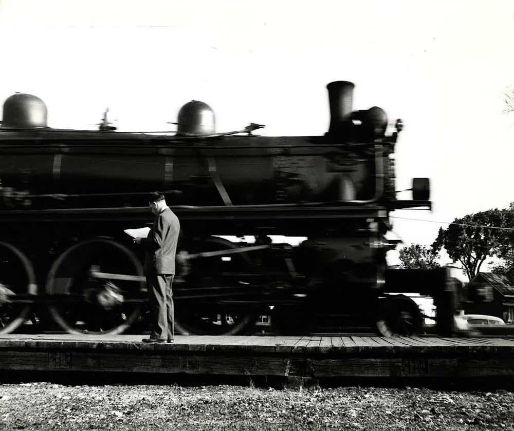 man standing in front of train