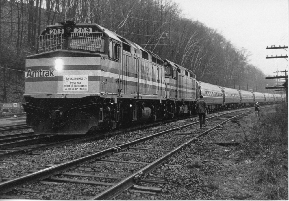 black and white Amtrak train on track