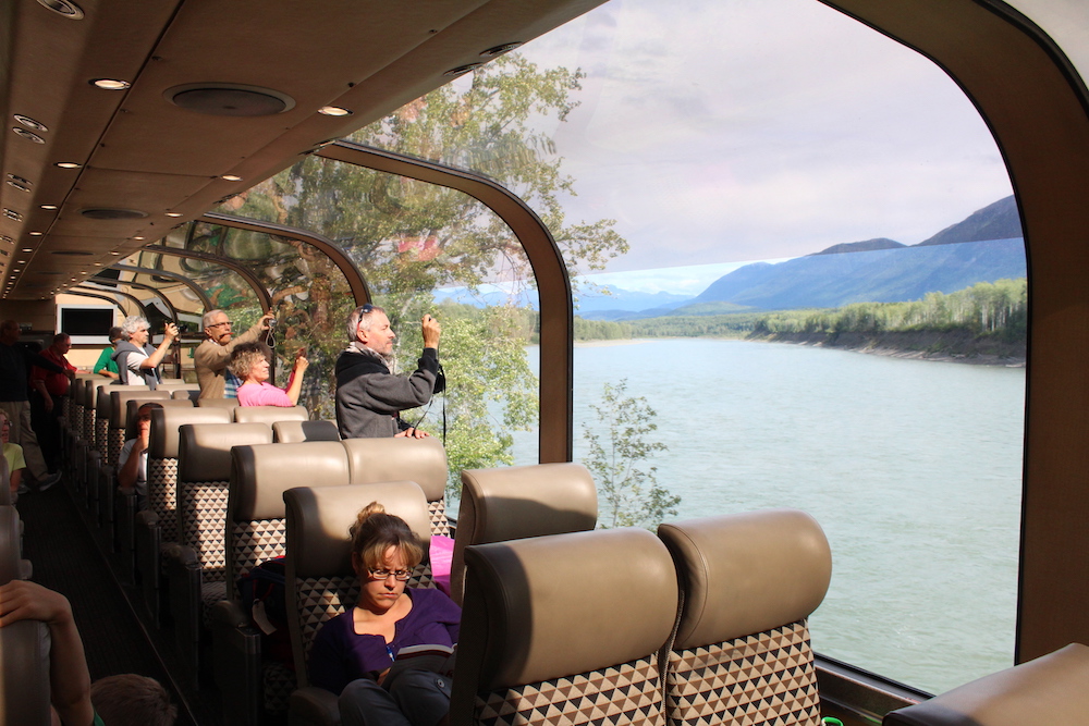 Passengers riding in a dome car.