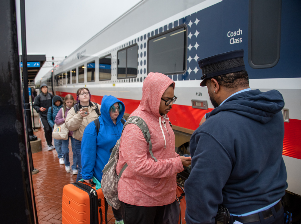 People lined up to board passenger train