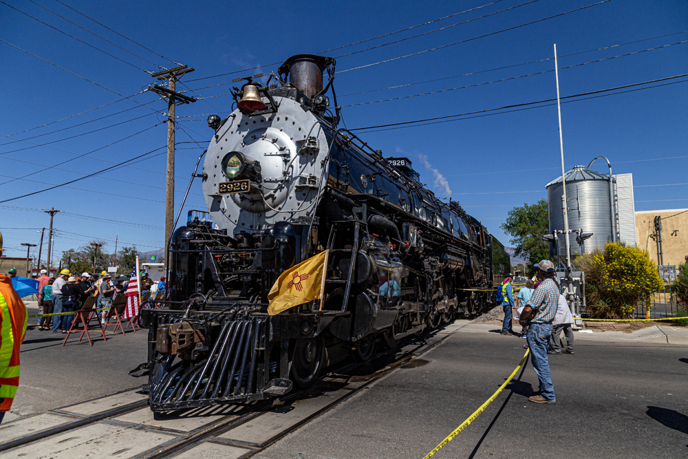 Three-quarter view of steam locomotive under blue skies