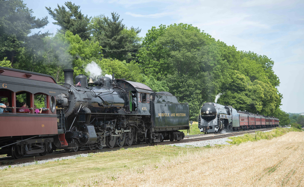 Trains with steam engines meet at siding