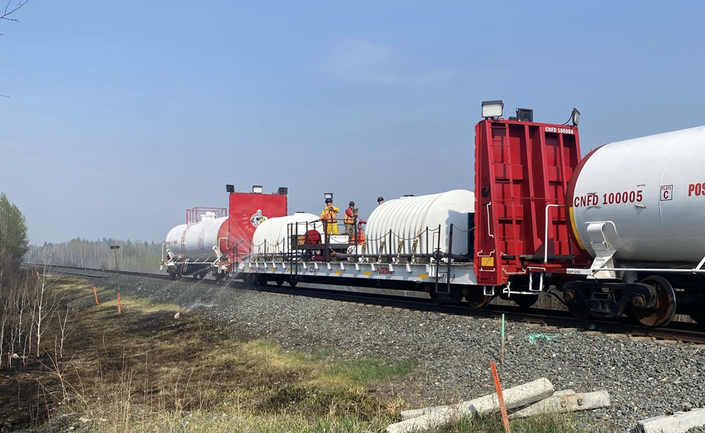 Red and white tank cars and flat car