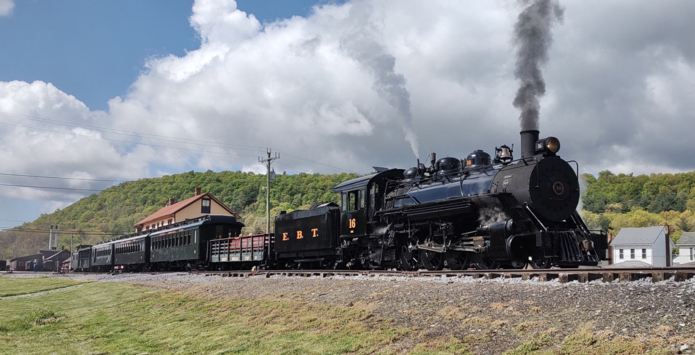 Steam locomotive and train at station