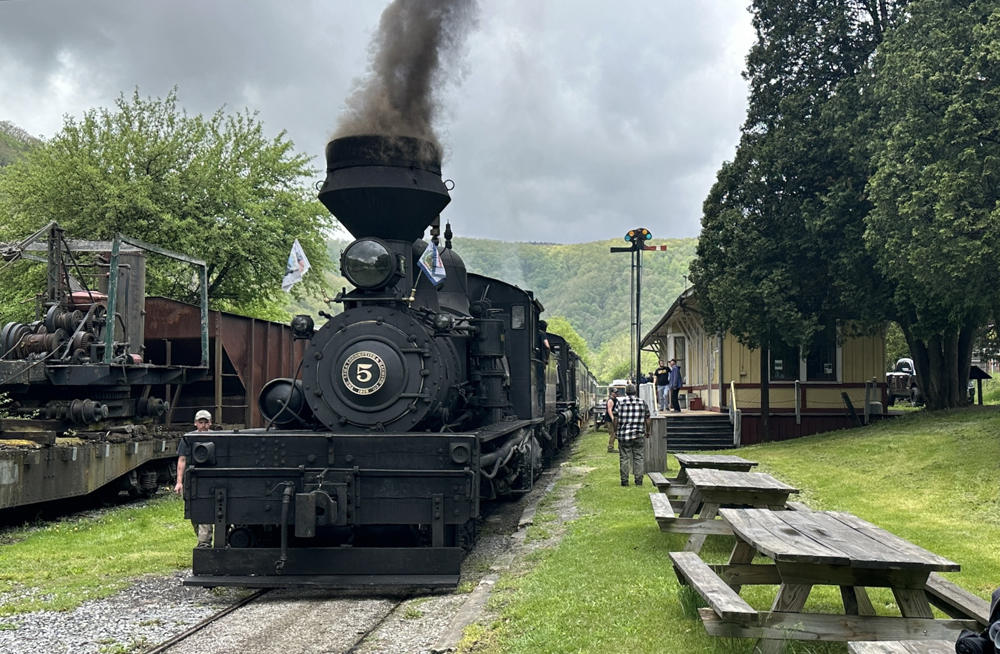 Train with two steam locomotives at station