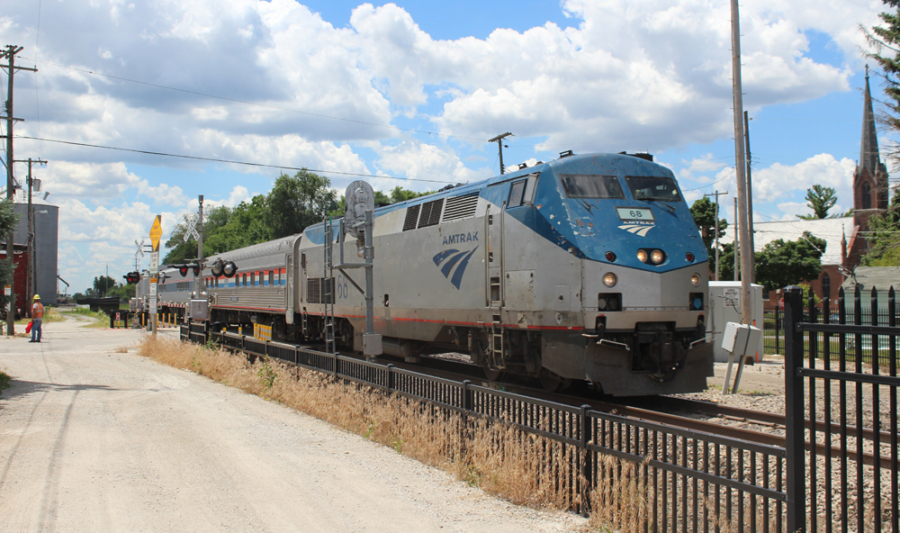 Short passenger train with beat-up locomotive