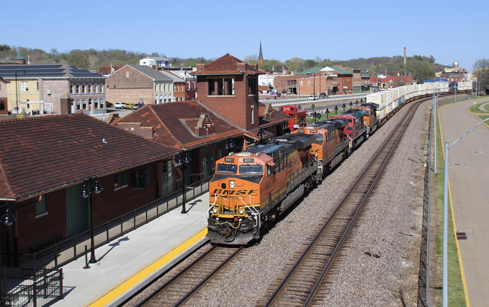 Intermodal train passing brick passenger station