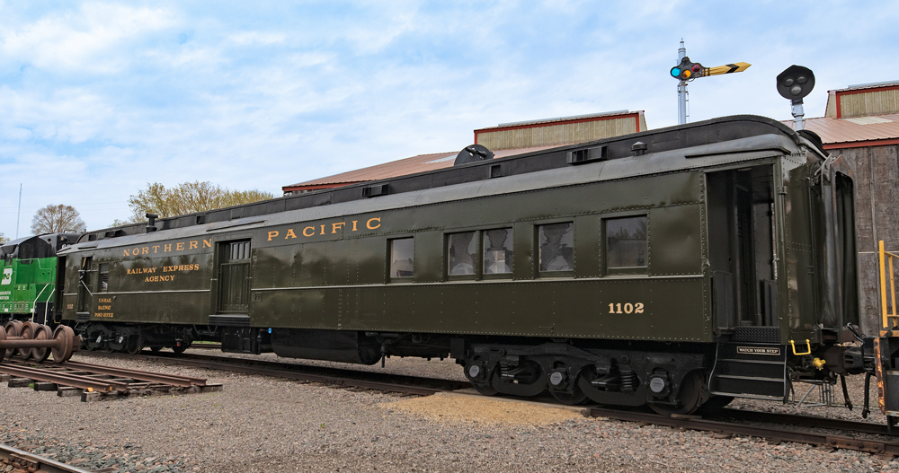 Pullman green heavyweight passenger car in fresh paint